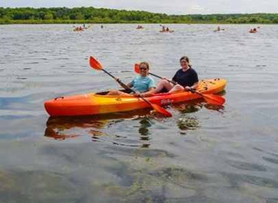 two people in an orange kayaks